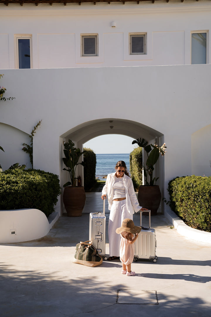 Arriving with a Silver PREZOR suitcase at a Mediterranean hotel