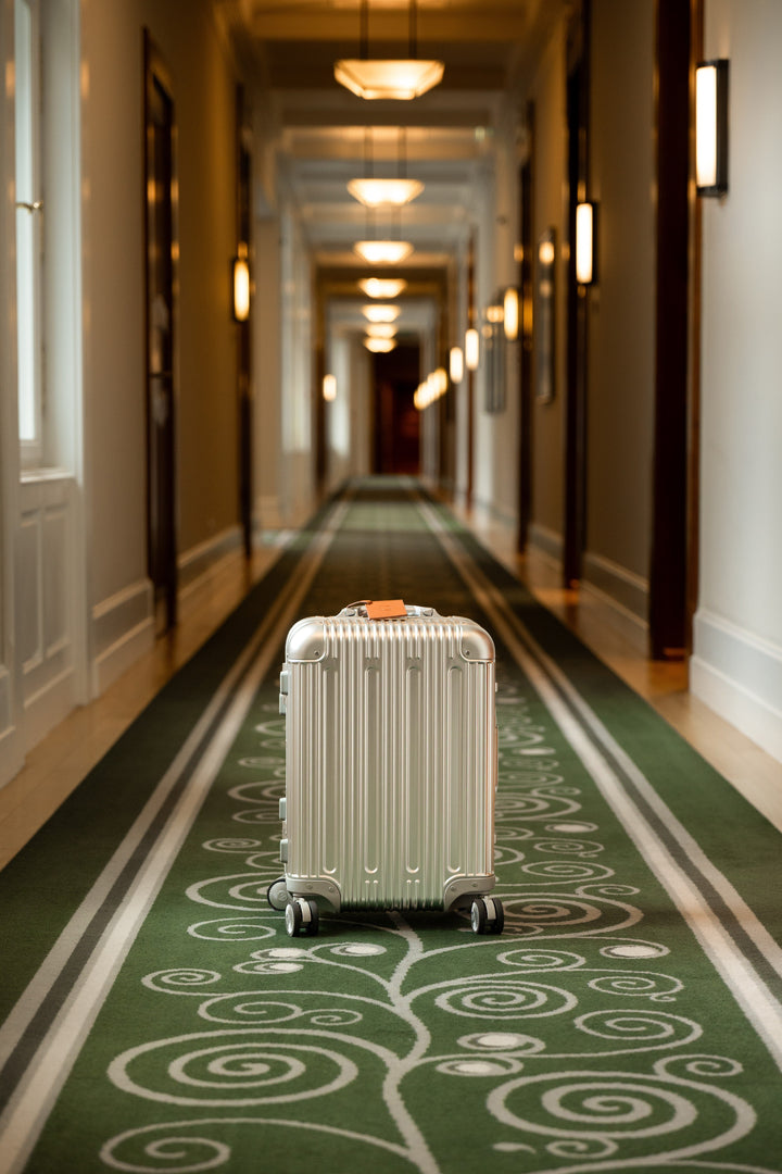 Silver PREZOR suitcase in the hotel